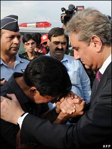 Pakistan"s Foreign Minister Shah Mahmood Qureshi comforts a relative of Pakistani student who was killed in ethnic riots in Kyrgyzstan