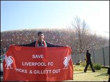 Ziyaad Hassam outside Soccer City Stadium in Johannesburg with one of the banners