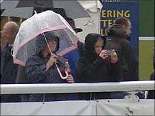 Show-goers watch in rain