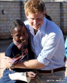 Prince Harry hugs a child affected by HIV-Aids