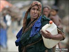 A woman carries a container of water in Satkhira, Bangladesh, in May 2010