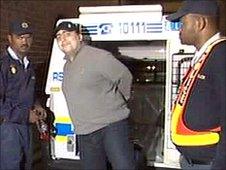 Pavlos Joseph being led out of a police van