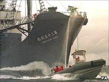 A Japanese whaling vessel and environmental protesters (Image: PA)