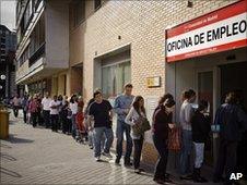 Unemployed workers in Spain queuing outside a job office