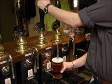 Man serving beer in pub