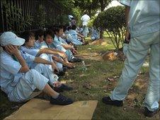 Workers rest during a strike at Denso in Guangdong province