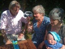 The Caufield family listen to the match on a wind-up radio