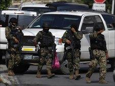 Mexican Marines walk on a street during an operation against organized crime and drug trafficking in a wealthy neighbourhood in Monterrey