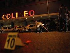 Agents of the State Agency of Investigations collect evidence outside Coliseo Arena in downtown Monterrey