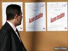 A passenger reads a notice that reads "no traffic" during a national strike at Strasbourg's railway station