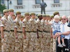 Henry Hicks, whose father Lance Corporal Darren Hicks was killed in Afghanistan, watches as the Coldstream Guards march along Horseguards to the Guards Memorial.