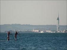 Stand-up paddlle surfing near Portsmouth's Spinnaker Tower