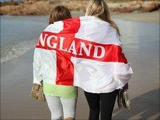 England fans walk along beach in Port Elizabeth, South Africa