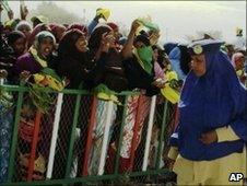 A policewoman stands in front of supporters of opposition Kulmiye party during a rally in Hargeisa