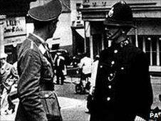 A Luftwaffe officer talks to a policeman in German-occupied St Helier, Jersey