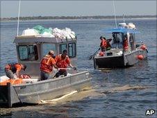 Boats cleaning up the oil spill