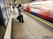 A passenger waits for a Tube train