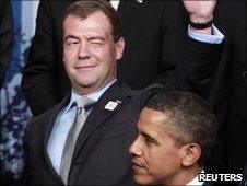 Russian President Dmitry Medvedev winks while standing next to US President Barack Obama