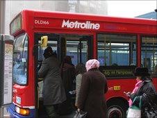 Passengers board a London bus