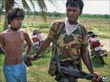 Indian security officer detains an alleged Maoist in West Bengal