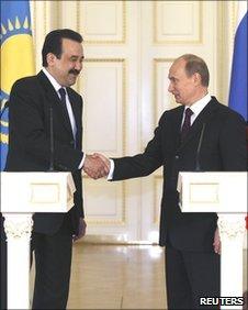 Russian Prime Minister Vladimir Putin and Kazakh Prime Minister Karim Masimov shake hands