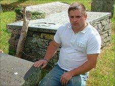 Tenant Tristin Partrick at the grave of Gerald Curgenven