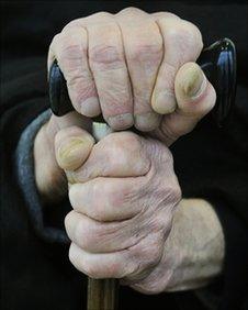 Elderly person with walking stick