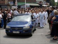 Mourners walk in funeral procession for the man killed by the explosion in Mitrovica (2 July 2010)