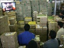 Workers in a market in Sao Paulo watch the Netherlands score