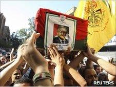 Mourners bear the coffin of Mohammed Oudeh through Yarmouk refugee camp, Syria, 3 July