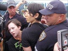 Takeru Kobayashi (c) is lead away by police