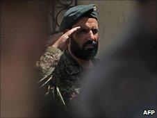 An Afghan soldier salutes during the change-of-command ceremony in Kabul on 4/7/2010