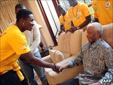 Ghanaian striker Asamoah Gyan (L) meets former South African President Nelson Mandela at his Johannesburg home - 3 July 2010