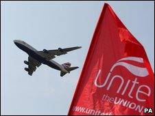 British Airways plane takes off over a union picket line