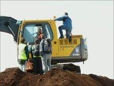 Protesters Iain Hilton and Sonny Khan chain themselves to machinery at Chat Moss