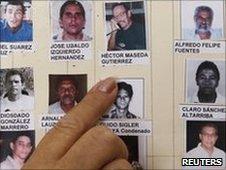 A woman points at pictures of Cuban political prisoners. Photo: June 2010