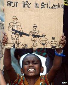 A young Sri Lankan asylum-seeker holds up a placard during a protest (2009)