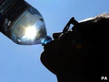 Woman drinking water in the sunshine