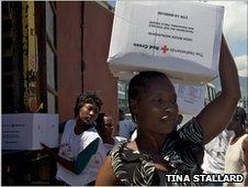 Aid workers carrying boxes