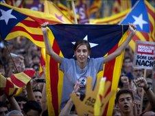 Demonstrators hold Catalan flags and shout slogans as they take part in protest in Barcelona, Spain, Saturday, July 10, 2010