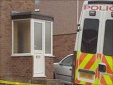 Police remain at the scene of the house