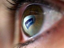 Eye with Facebook sign reflected in it