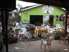 Damaged chairs and tables amongst the debris strewn outside the Ethiopian Village restaurant in Kampala. Photo: 12 July 2010