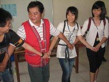 Group dancing with the musical instruments on their backs