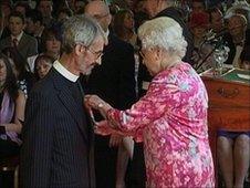 Reverend Andrew Jolly receiving MBE from the Queen