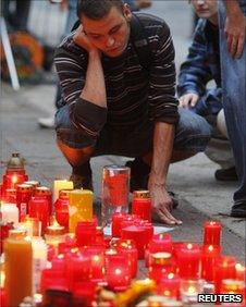 A man looks at tributes left in memory of those who died at Love Parade