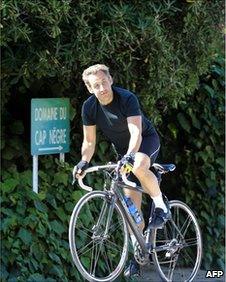 French President Nicolas Sarkozy rides a bicycle in Lavandou, Cap Negre, France, on 5 August, 2010