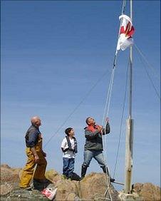 Flag raised on Grosse Rocque in 2009