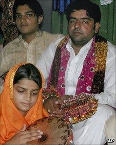 Azhar Haidri (right) sits with relatives during his first wedding ceremony in Multan on Sunday