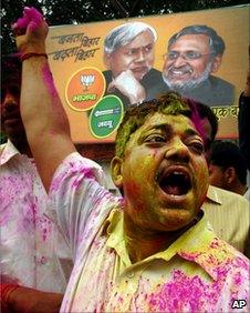 A Nitish supporter celebrates the Bihar election results in Patna on 24 Nov 2010